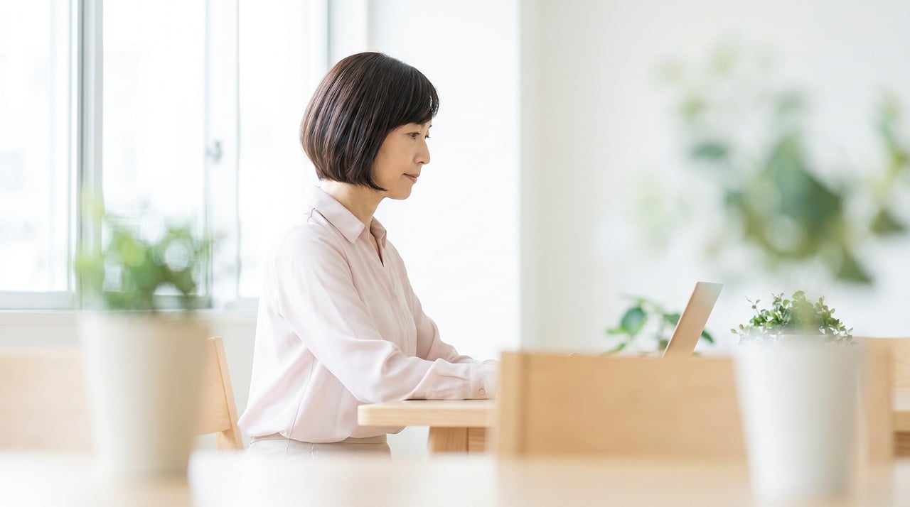 Woman, asian, laptop — The Significance of ISO 13485 Regular